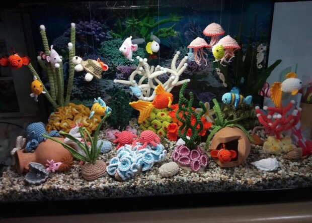 Die Frau strickte realistisches Aquarium aus dem Farbgarn
