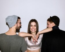 Happy girl in relationship with two men